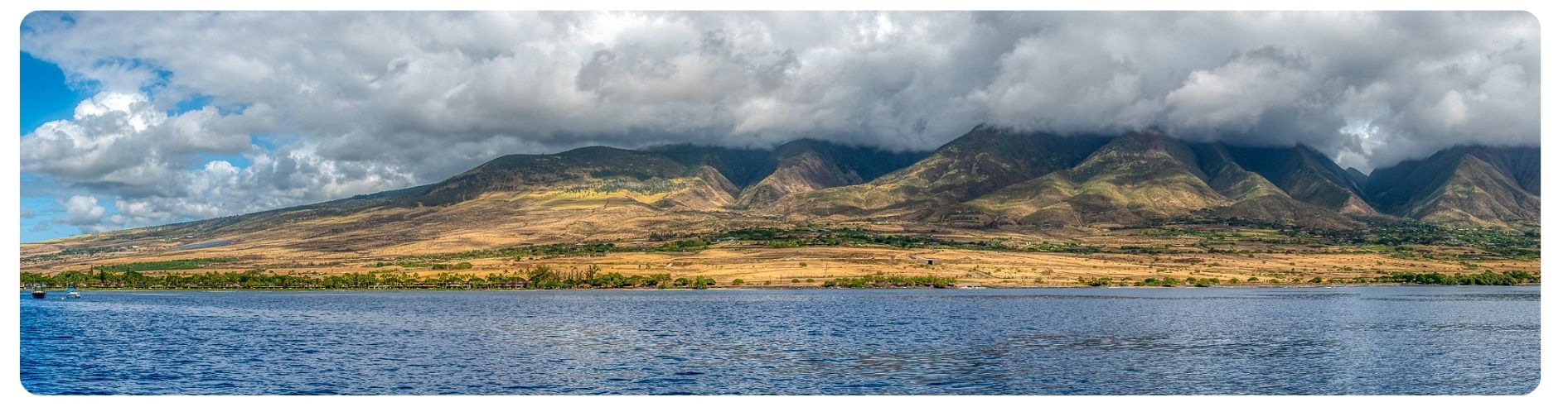 ocean with mountainous landscape behind