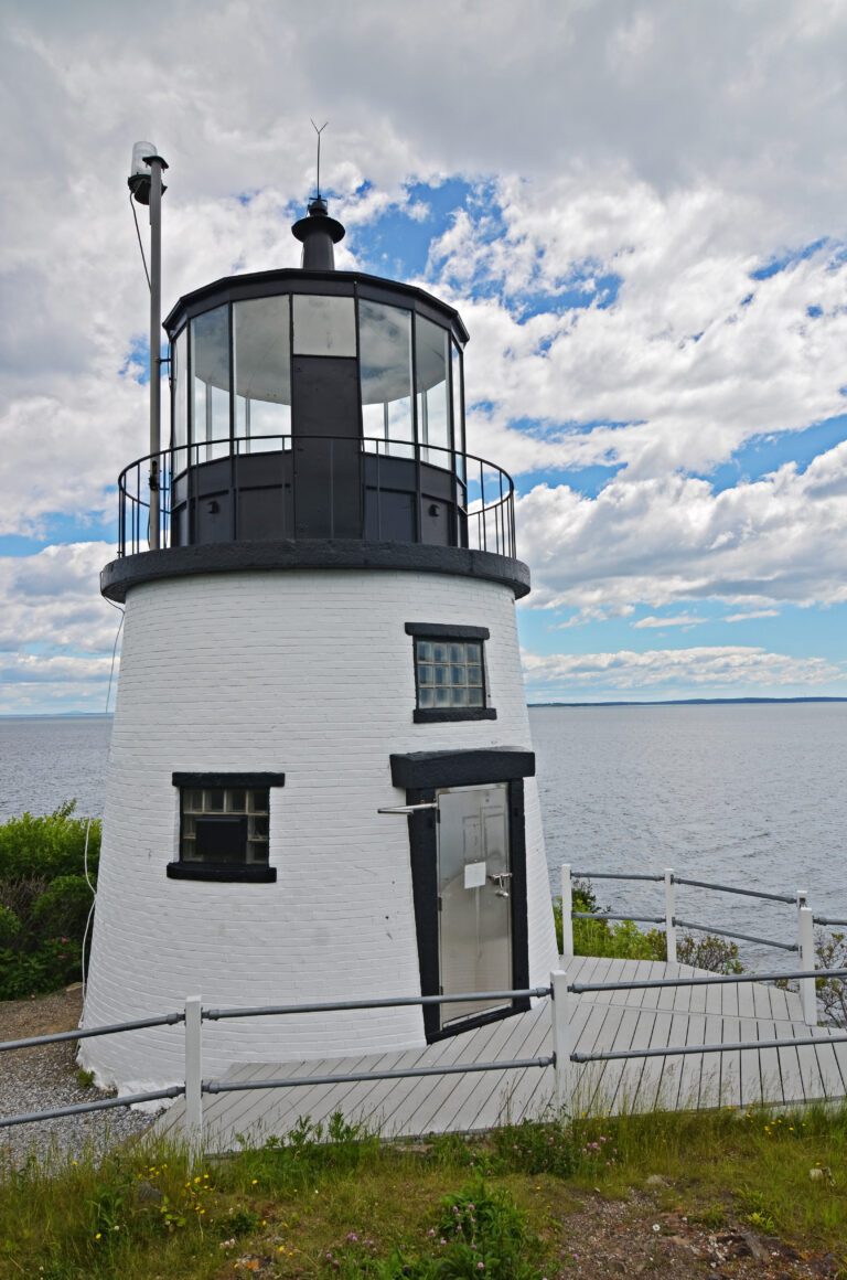 lighthouse with blue sky backdrop