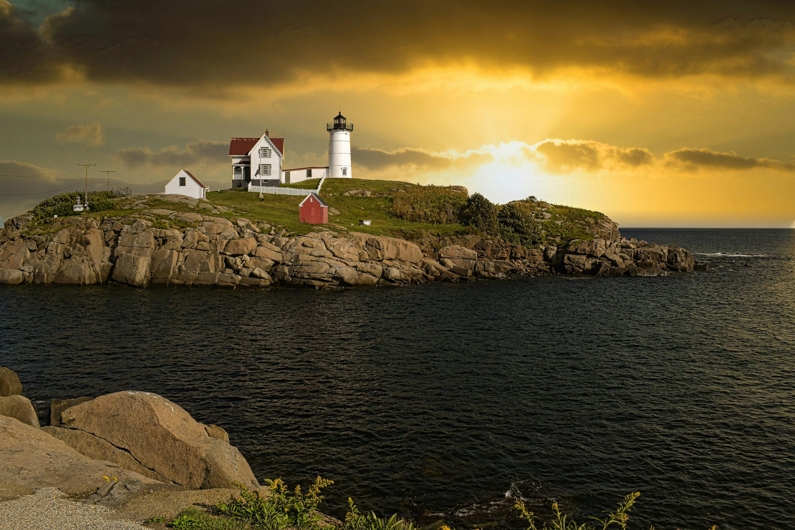 lighthouse with sun setting on horizon